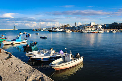 Boats moored at harbor in city