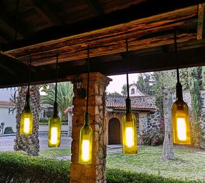 Illuminated lanterns hanging by building