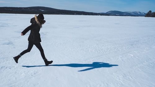 Full length of man skiing on snow against sky