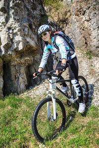 Woman riding bicycle on mountain