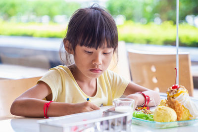 Portrait of a girl sitting on table