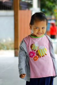 Portrait of boy standing outdoors