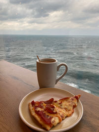 Breakfast on table against sea and sky