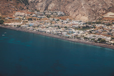 Scenic view of river by buildings on sunny day