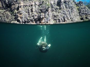 High angle view of woman swimming undersea