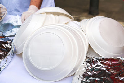 A pile of plastic plates on the street. ban disposable plastic utensils. ecology concept. close-up