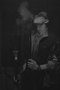 Young man smoking at home
