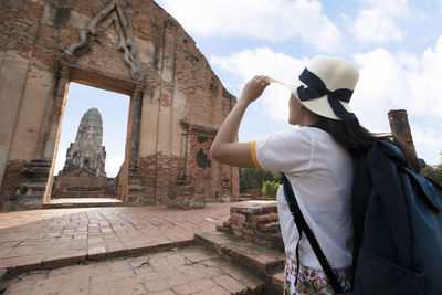 Rear view of man in temple against building