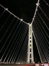 Low angle view of illuminated skyscraper at night