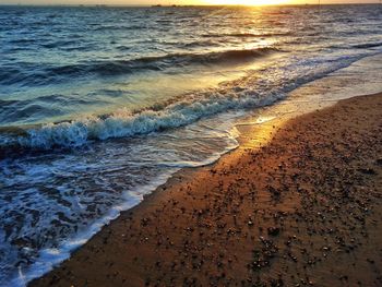 Scenic view of beach against sky during sunset