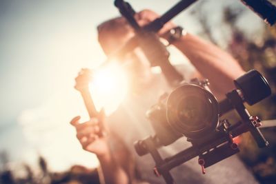 Man holding digital video camera on gimbal