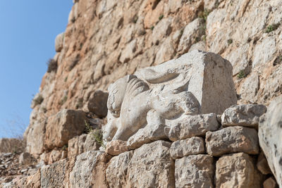 Low angle view of statue against rock formation