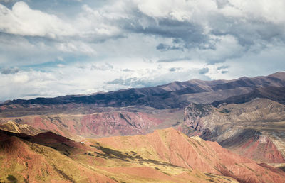 Scenic view of mountains against cloudy sky