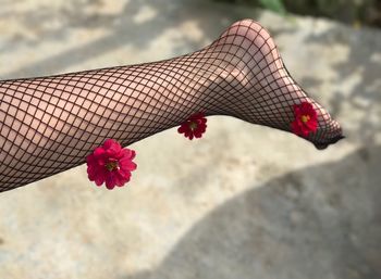 Low section of woman wearing stockings with flowers