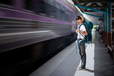 Full length of young man at railroad station