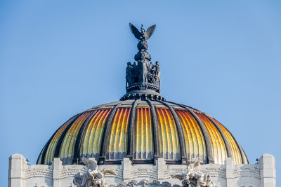 Low angle view of building against clear blue sky