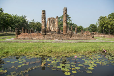 Built structure in lake with trees in background