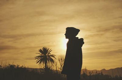 Silhouette man against sky during sunset