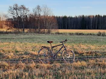 Bicycle on field against sky