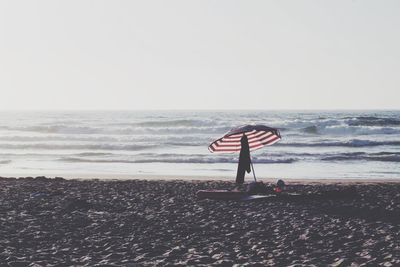 Scenic view of beach against clear sky