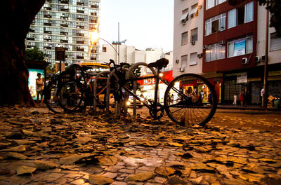 Bicycles in city against sky