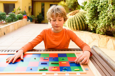 Boy playing checkerboard