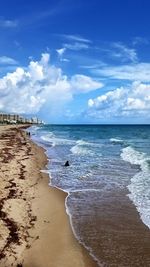 Scenic view of beach against blue sky