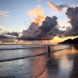Scenic view of sea against cloudy sky