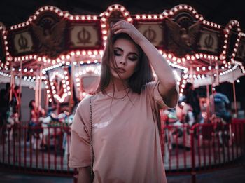 Woman in amusement park ride at night