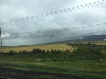 Scenic view of landscape against cloudy sky