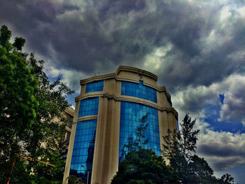 Low angle view of building against cloudy sky