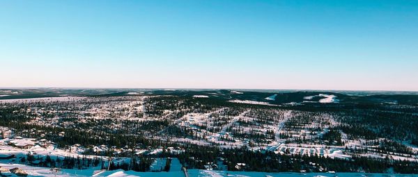 Aerial view of cityscape against clear sky during winter