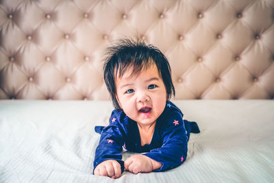 Portrait of cute baby boy sleeping on bed at home