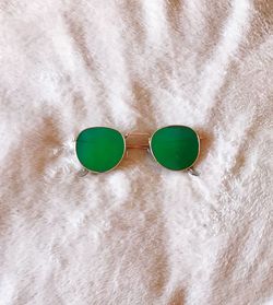 High angle view of sunglasses on bed