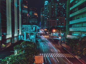 Illuminated city street and buildings at night