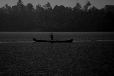 Silhouette of boat in river