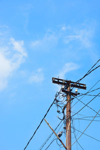 Low angle view of electricity pylon against sky
