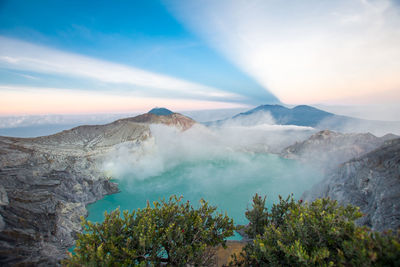 High angle view of hot spring by rock formation