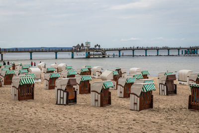 People at beach against sky