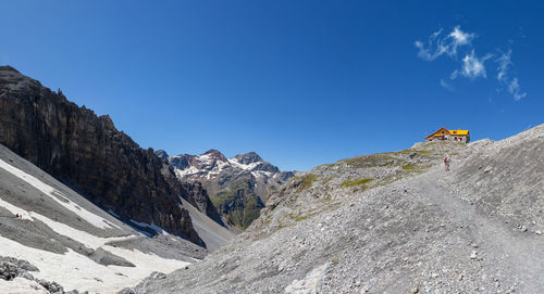 Low angle view of person on rock against sky