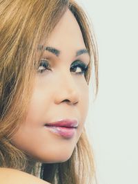 Close-up portrait of a beautiful young woman over white background