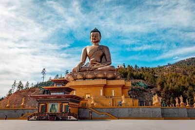 Large statue at temple against sky