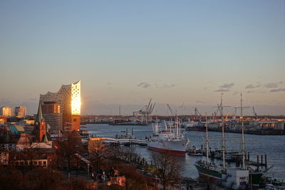 Sailboats in sea against sky during sunset