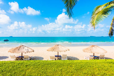 Scenic view of beach against cloudy sky