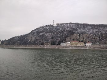Scenic view of sea and mountains against sky