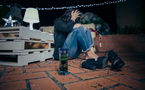 Drunk young woman during party in backyard at night