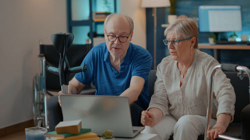 Senior couple looking at laptop