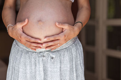 Midsection of woman standing against blurred background