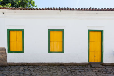 Exterior of yellow house by building
