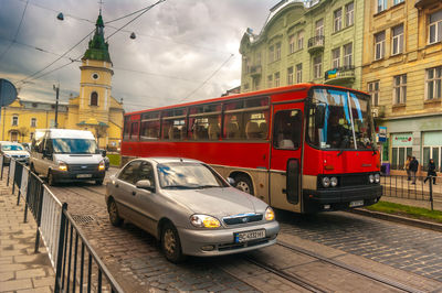 Cars on street by buildings in city